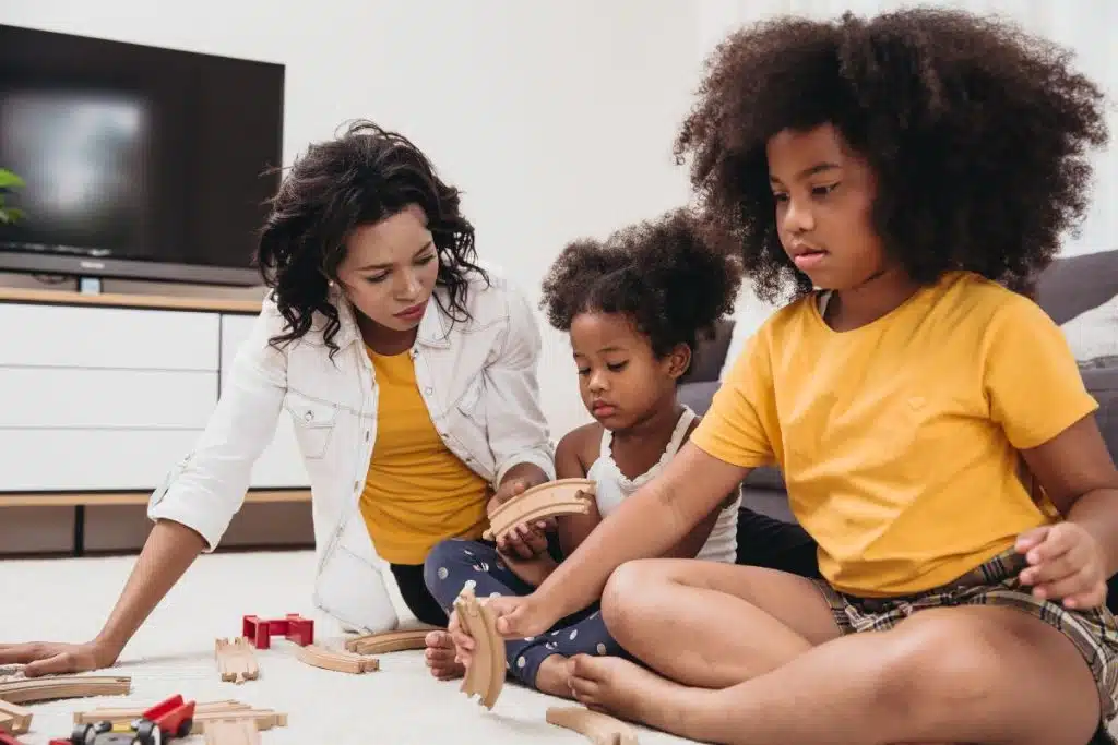 Inclusive nanny engaging with multiracial children in a culturally rich Houston home