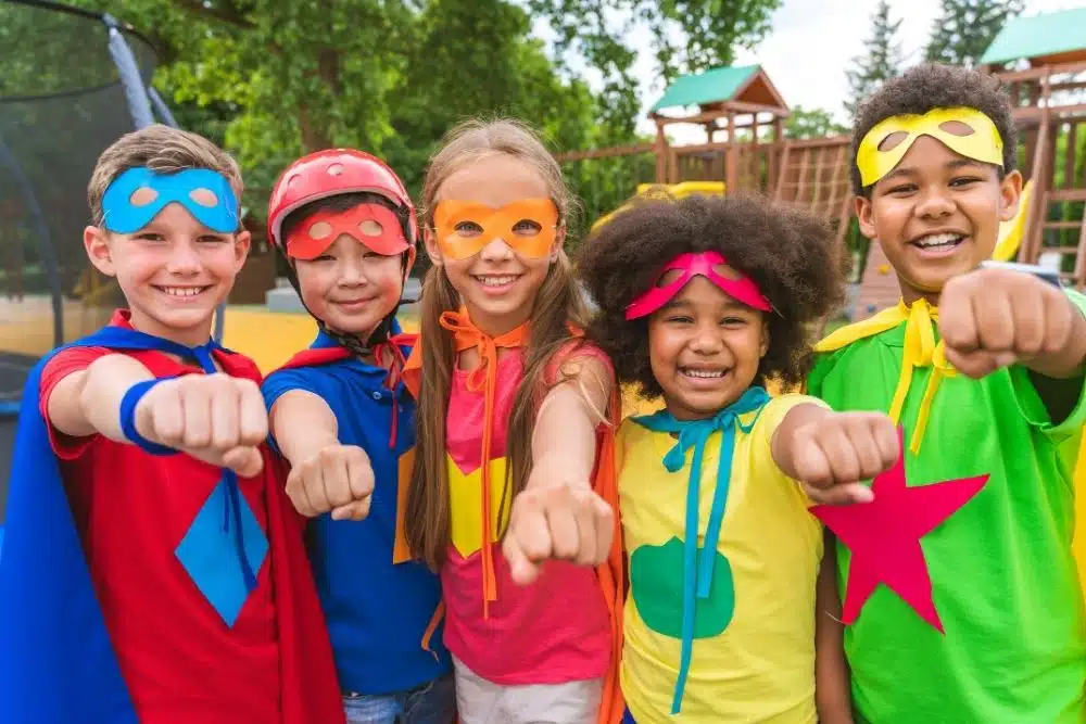 A group of young children dressed in costumes for a theme day at Kidventure’s Passport to Adventure summer camp.