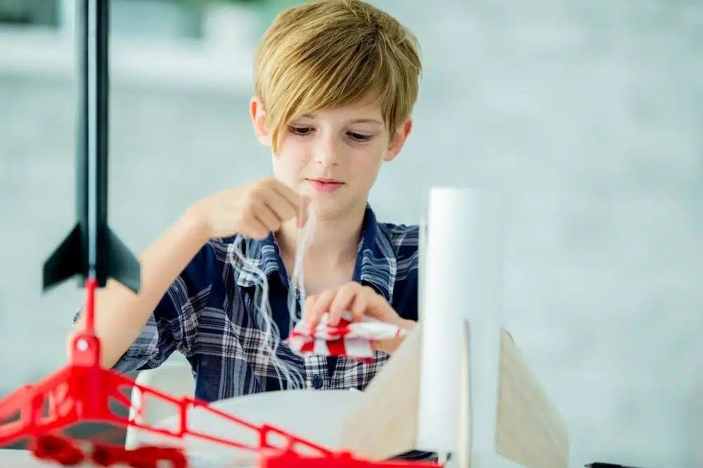 Kids building model rockets at Explorer Camp in Space Center Houston.
