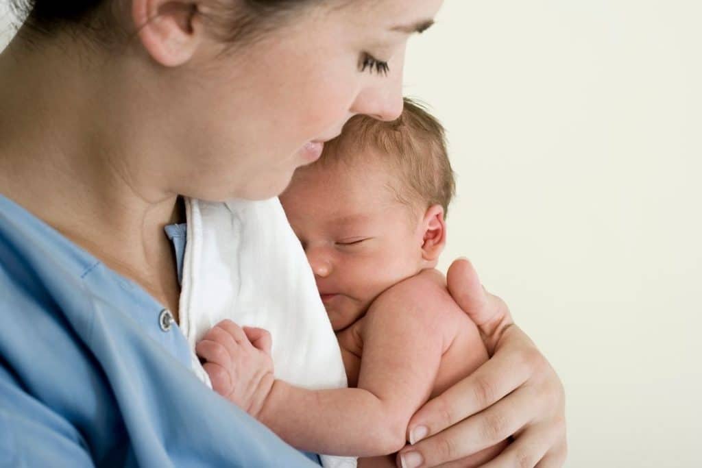 Licensed night nurse providing overnight care to a newborn with medical needs