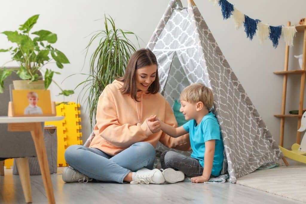 Professional nanny teaching children confidence and kindness through play