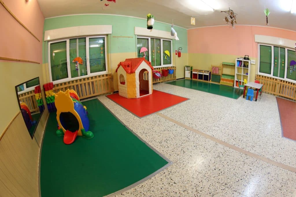 Daycare center in Houston with children playing, representing high childcare costs