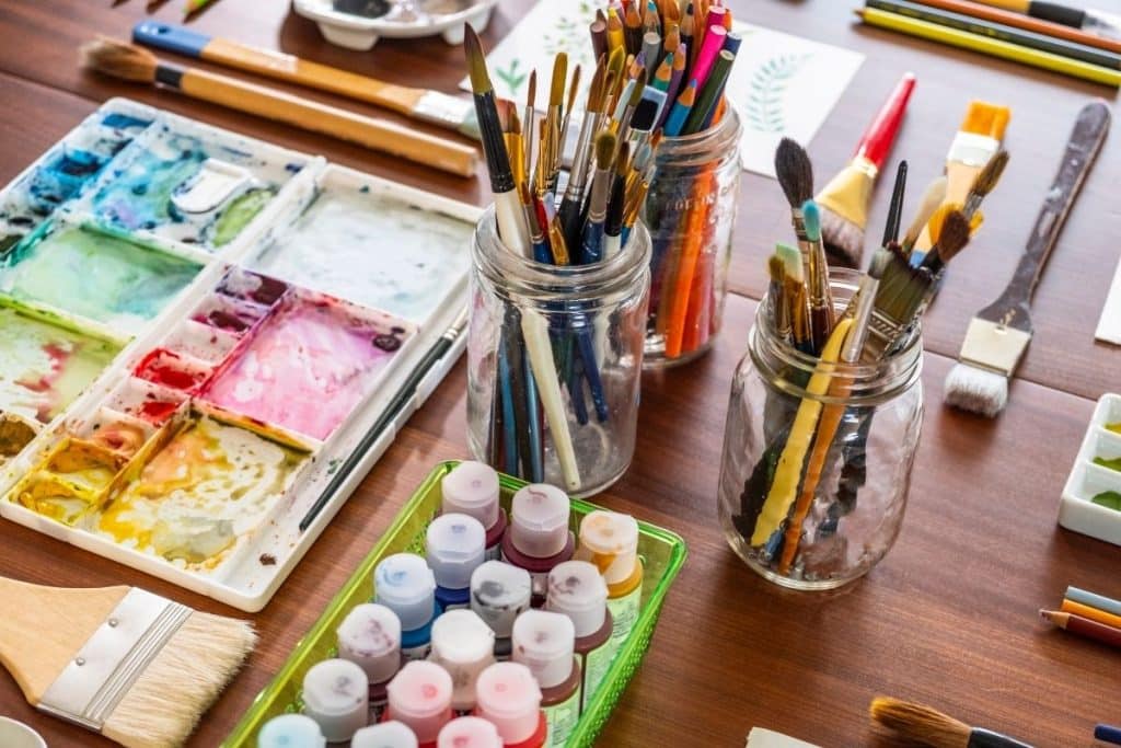 Nanny organizing art supplies and games for children at home.