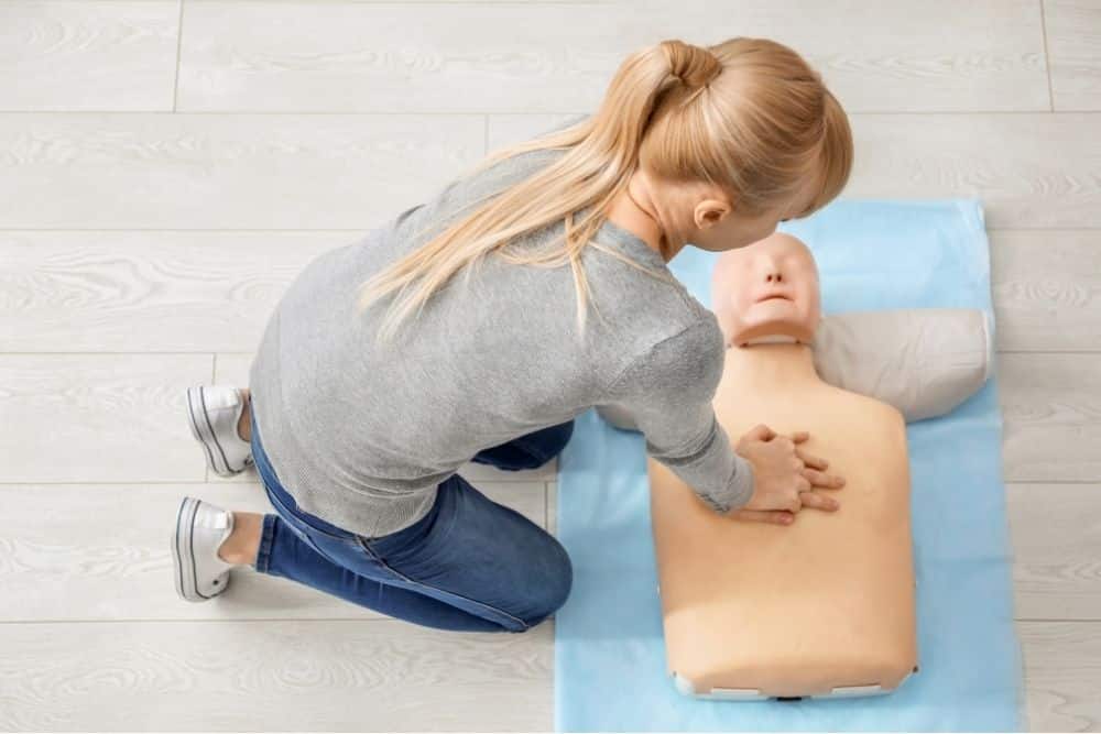 Houston nanny proudly displaying her CPR and childcare certifications in a home setting.