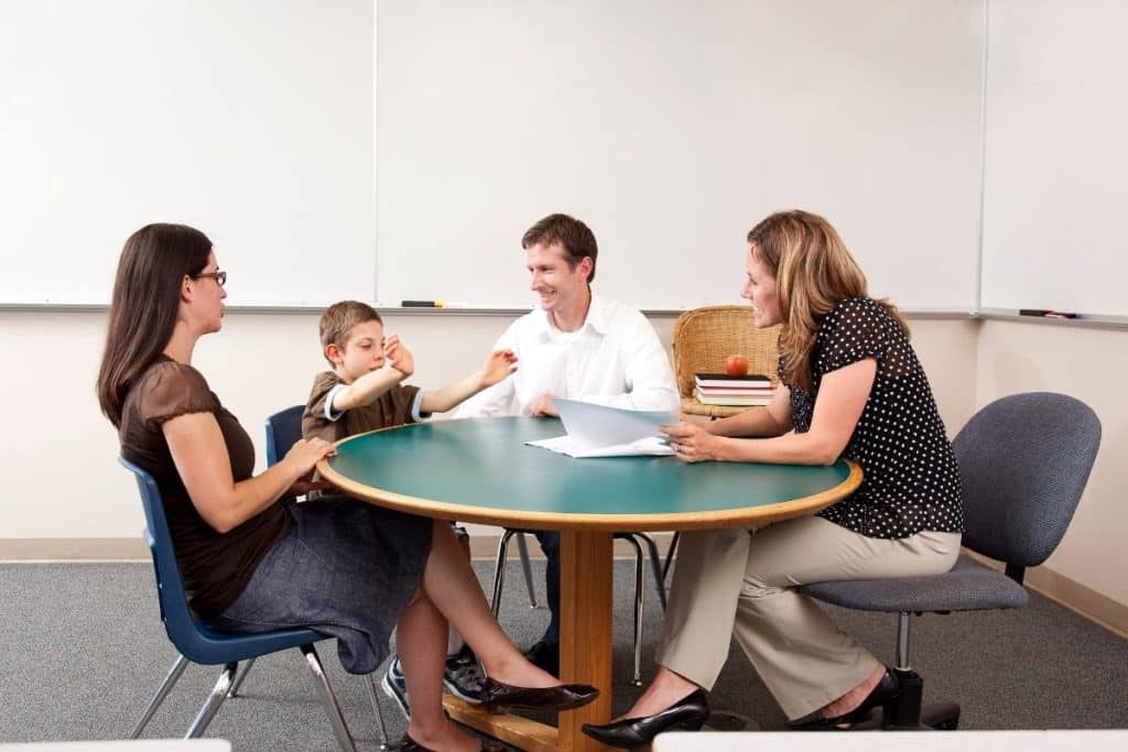 Houston parents discussing nanny pay and benefits with a professional childcare provider.