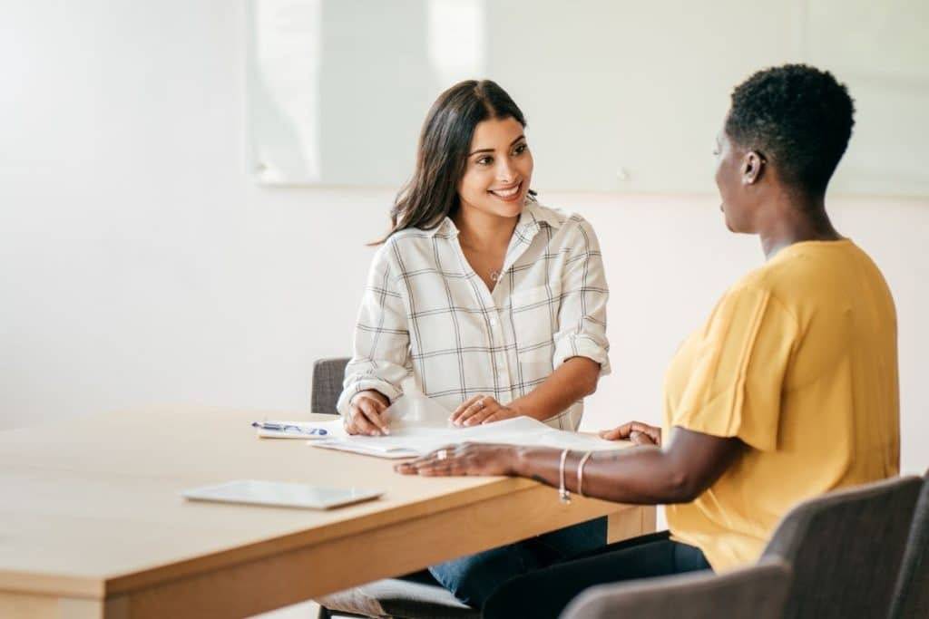Parents interviewing a professional nanny in their Houston living room.
