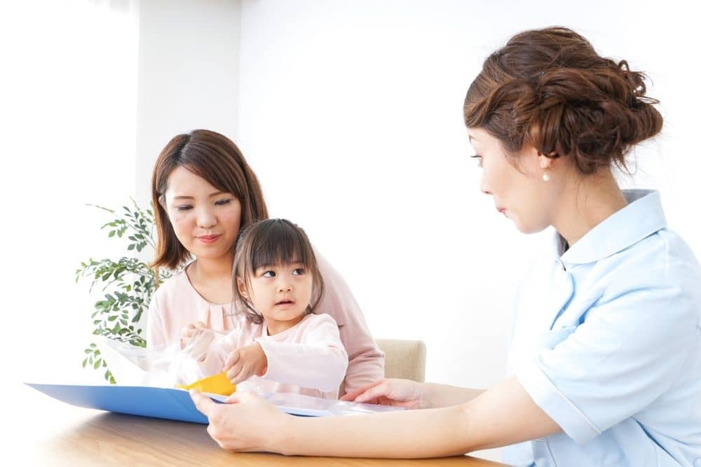 Parents discussing childcare routines with a professional nanny in a cozy Houston home.