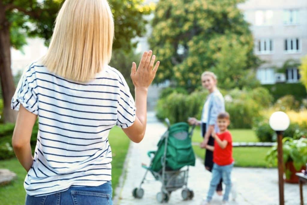 Houston parents waving goodbye to their nanny while leaving for work, showing flexibility and peace of mind.