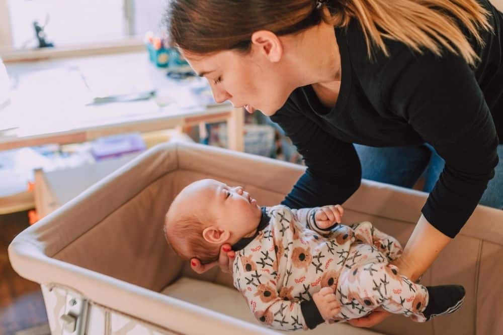 Newborn care specialist working with parents in a living room on newborn feeding schedules