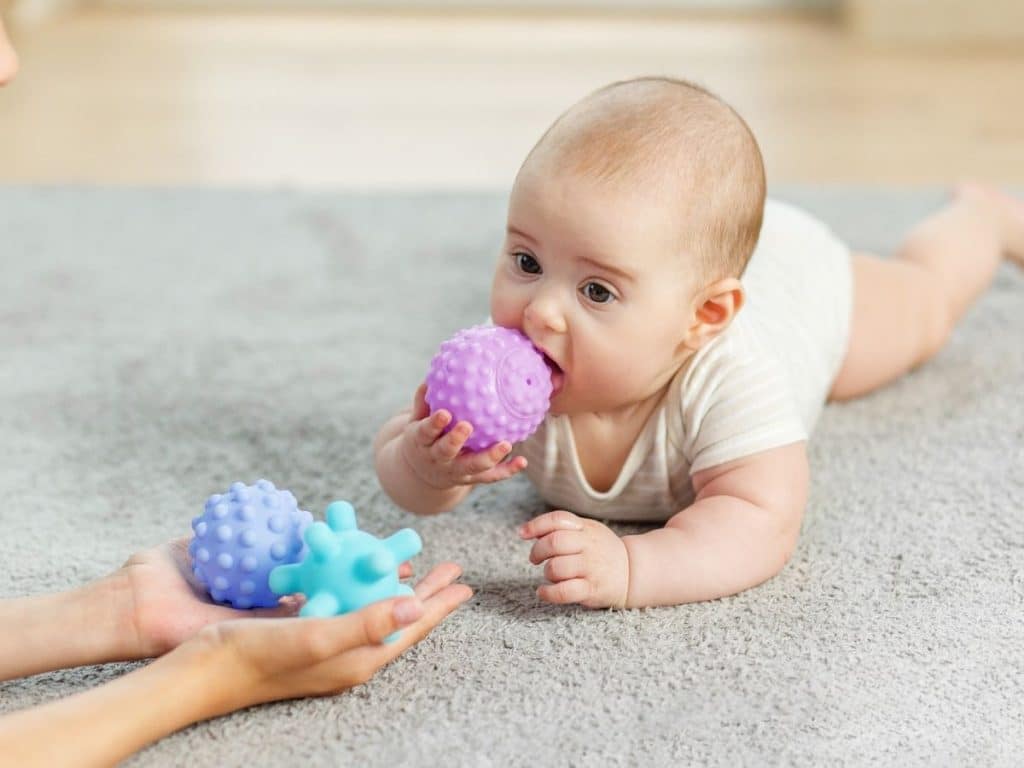 Part-time Houston nanny playing with a toddler in a safe and bright home environment.