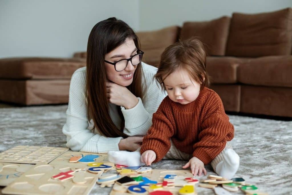 Houston nanny playing educational games with a baby to support early learning and development.