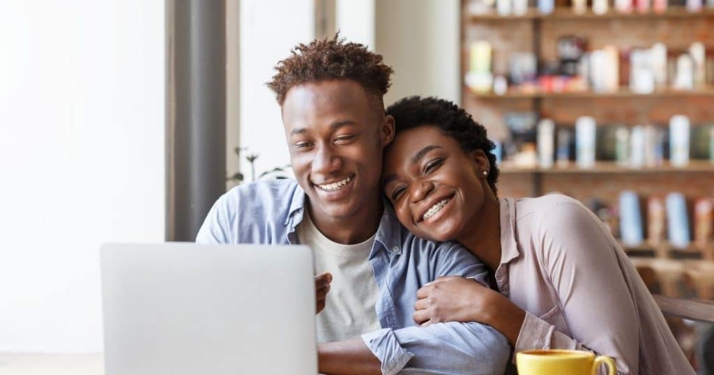 Parent in Houston booking a night nanny for the holidays on a laptop