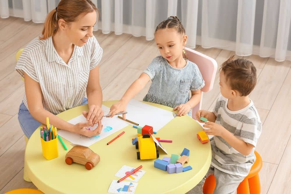 Houston family and nanny smiling together in a living room, symbolizing trust and teamwork.