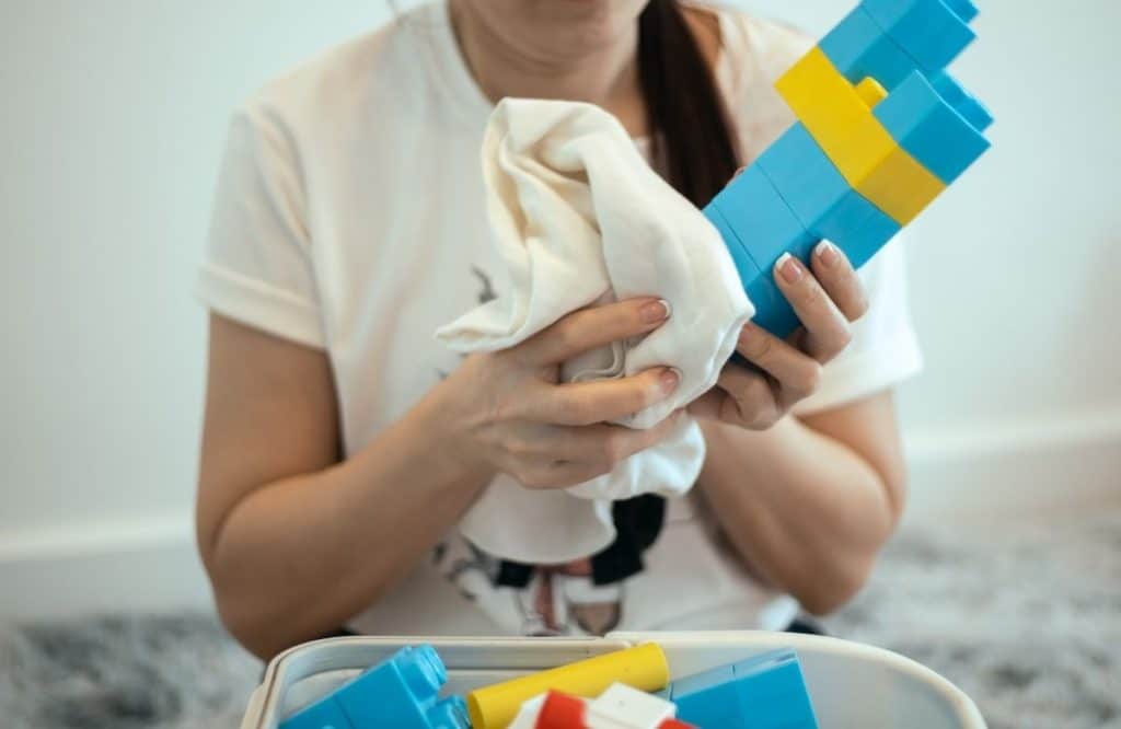 Backup nanny sanitizing toys and maintaining a clean home during cold and flu season in Houston.