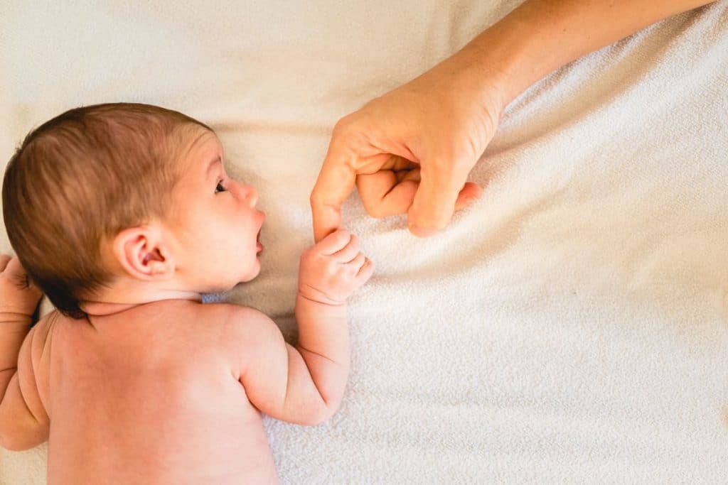 Certified newborn care specialist supporting a newborn during winter months