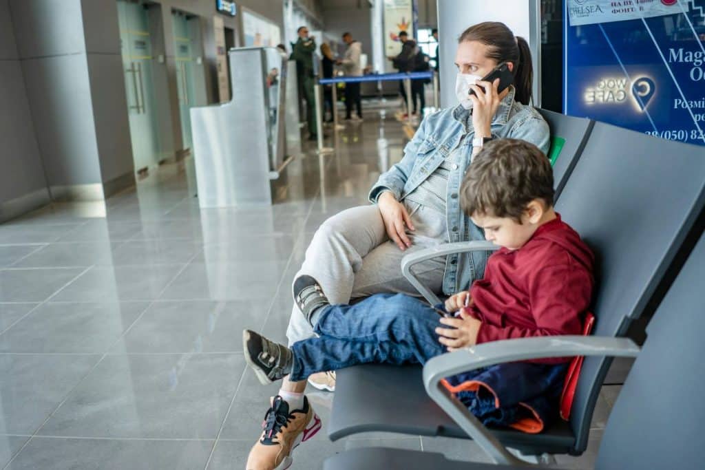 Elite travel nanny helping a Texas family at the airport during winter travel.