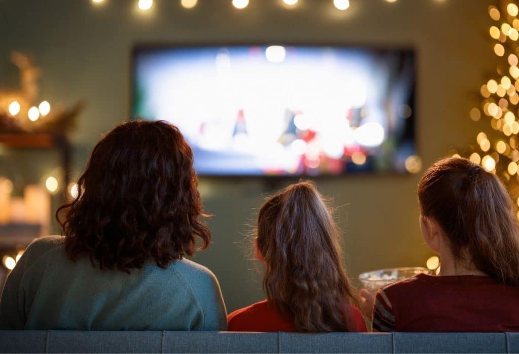 Professional nanny caring for children during a luxury winter vacation.