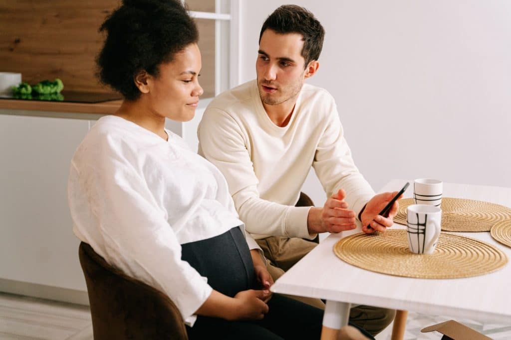 Expecting parents discussing newborn care needs and support options