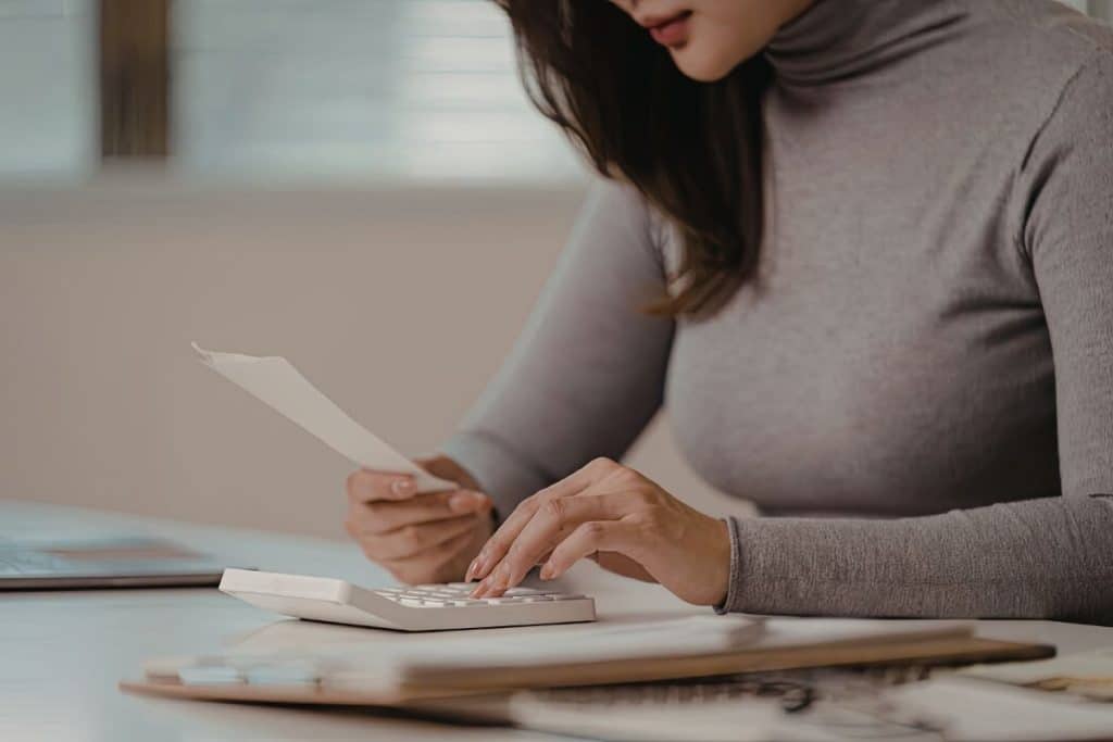 Parent reviewing household employee tax documents at kitchen table