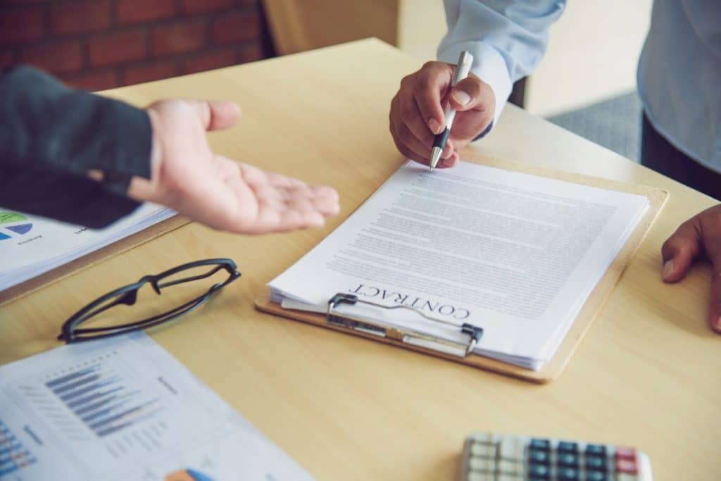 Parents reviewing a transparent nanny agency contract and fee agreement