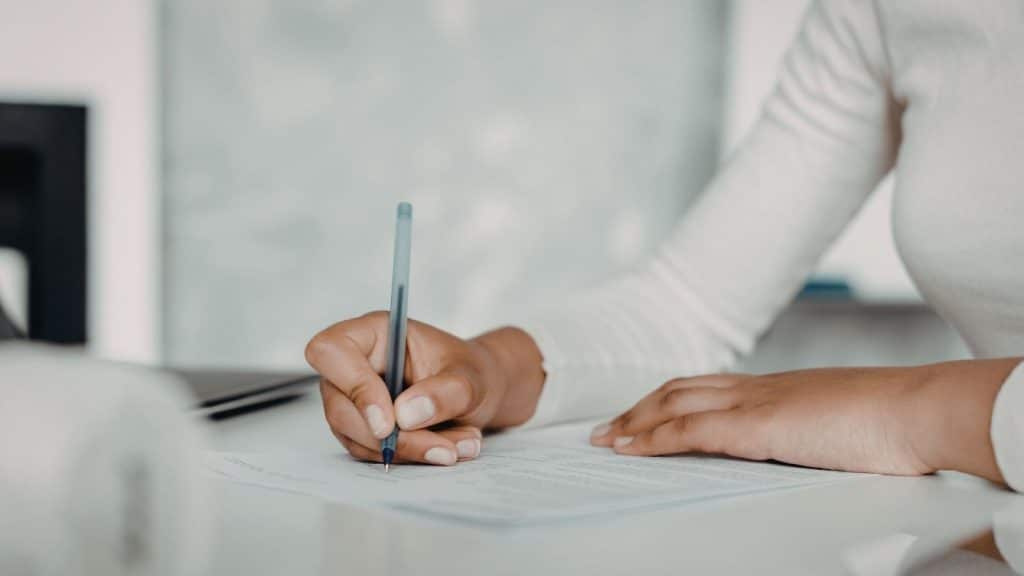 Professional nanny signing a confidentiality agreement in a private household setting.