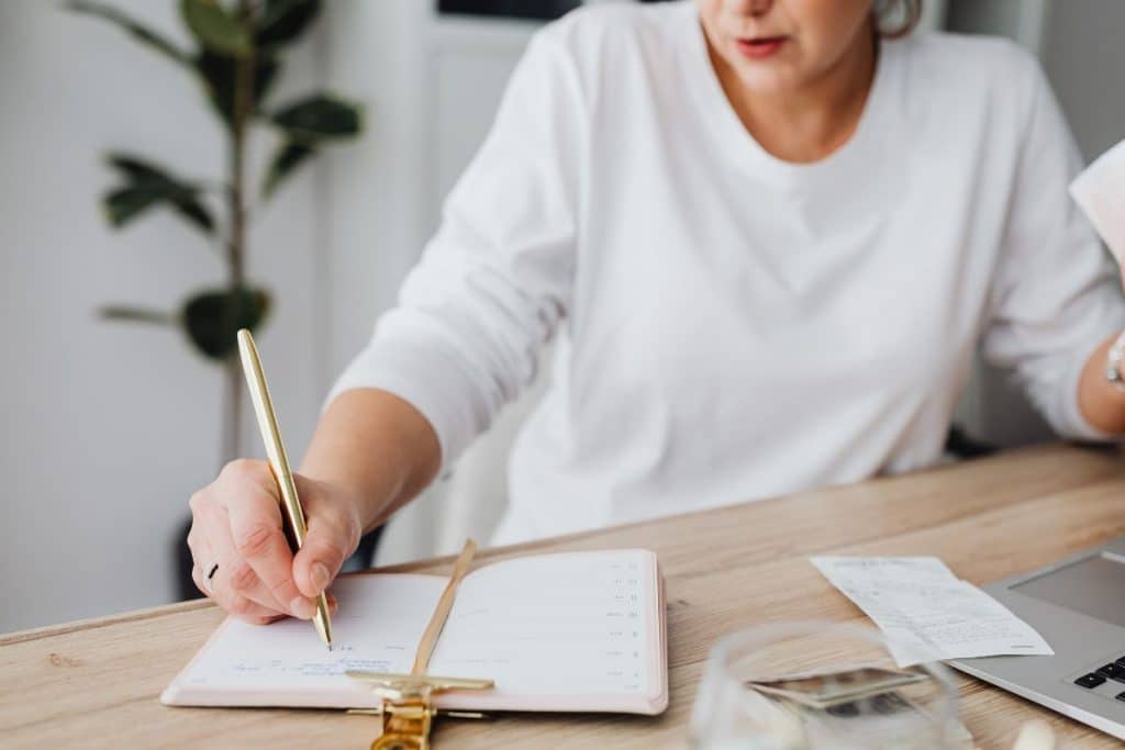 Nanny reviewing child’s daily schedule and routine chart in organized home