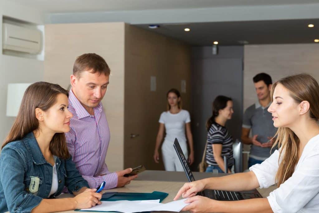 parents discussing childcare needs with nanny agency consultant