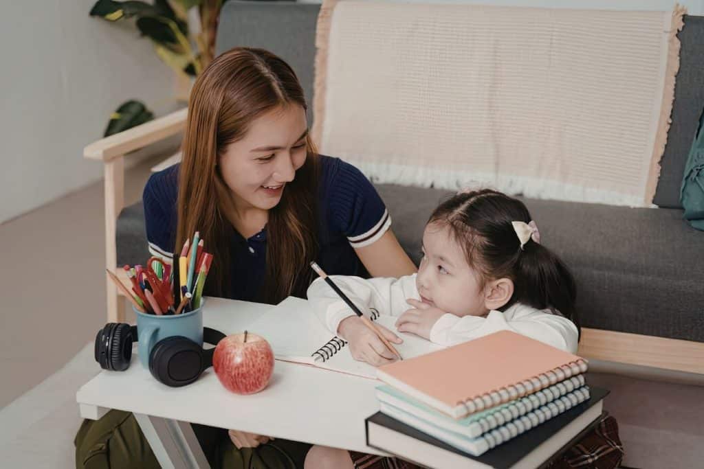 Professional nanny helping a child with educational learning activities