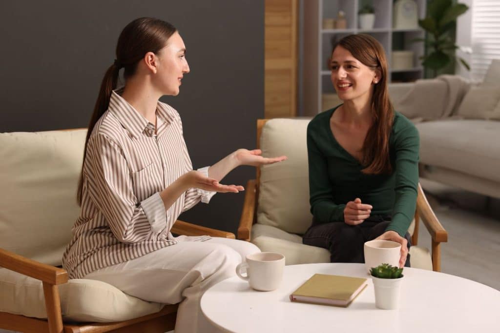 Parent explaining daily routines and schedules to a new nanny