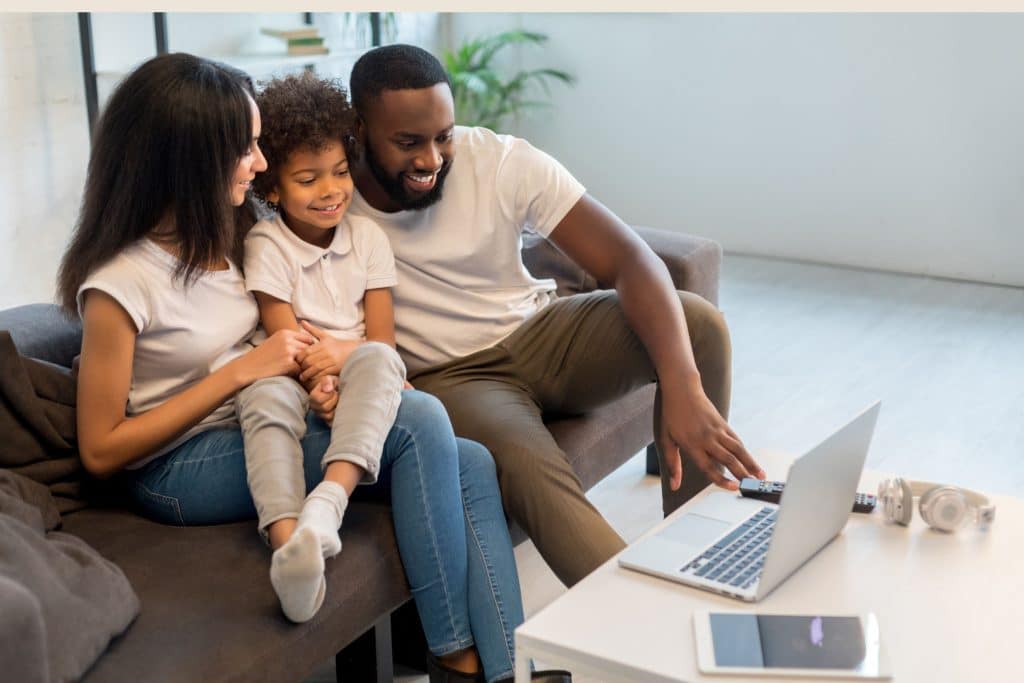 Parent reviewing nanny applications on laptop during hiring process