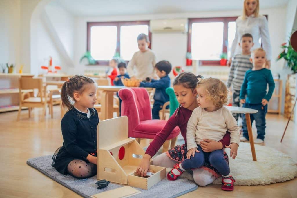 Busy daycare classroom with multiple children and high activity