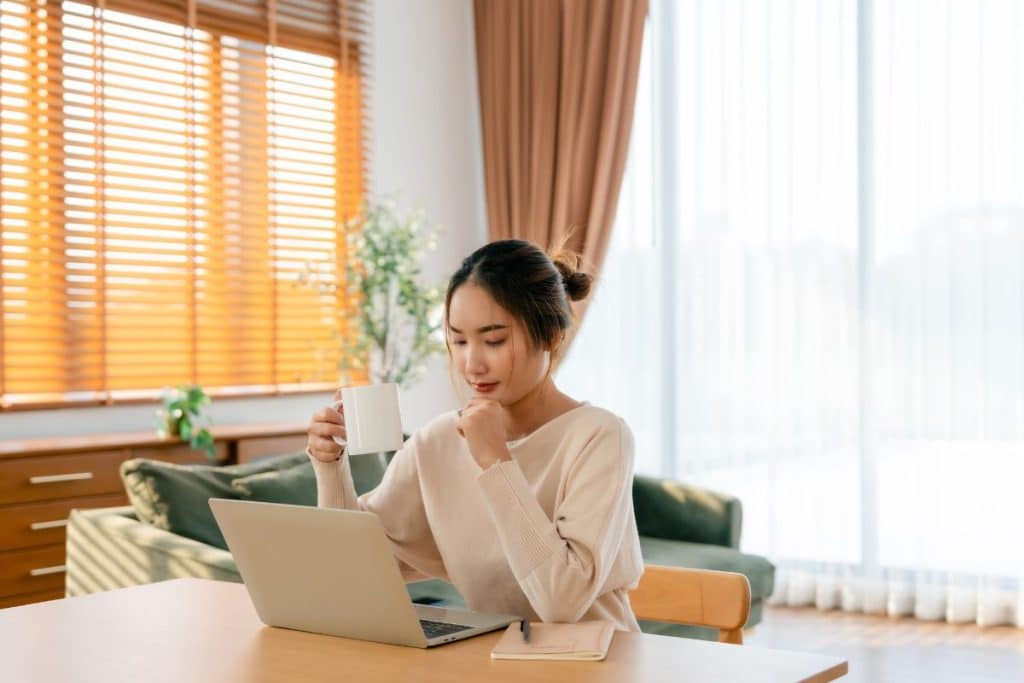 Recruiter reviewing nanny applications and conducting background checks on a computer