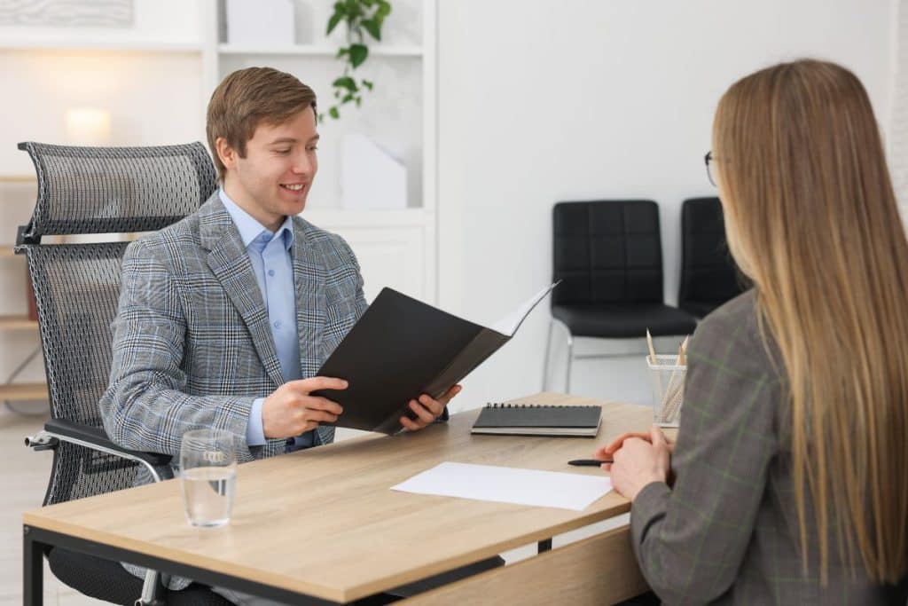 Professional reviewing vetted nanny candidate profiles and background checks