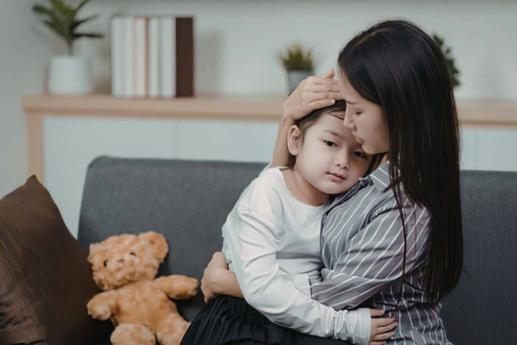 Nanny comforting and engaging emotionally with young child