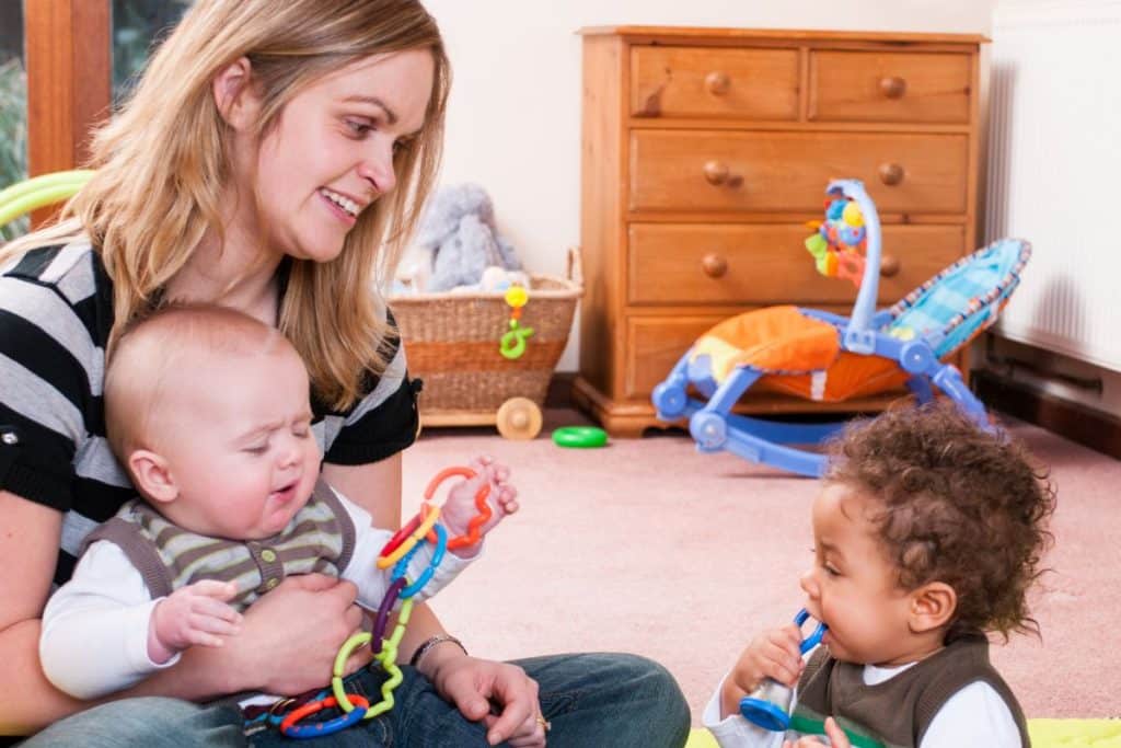 Professional nanny engaging children in structured educational play activities