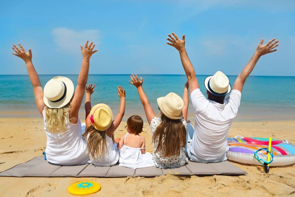 Family enjoying a memorable summer vacation with the support of a professional travel nanny.