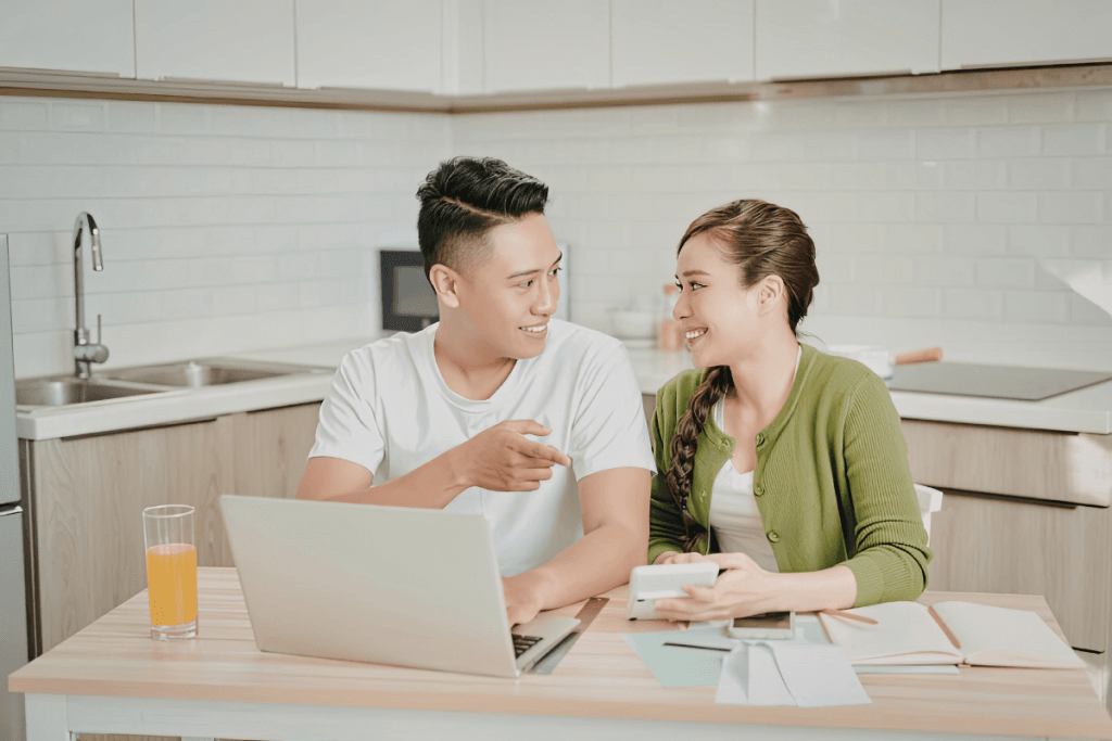 Parents calculating childcare expenses while comparing full-time and part-time nanny costs.