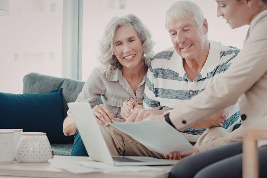 Parents and nanny reviewing a childcare contract that includes guaranteed hours.