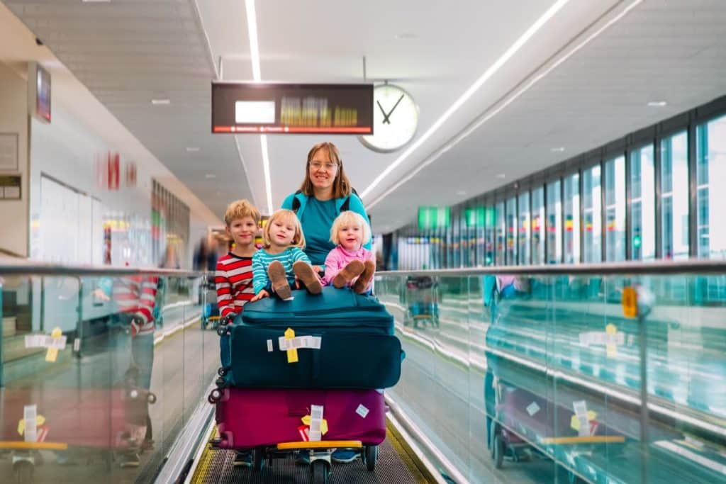 Travel nanny helping children and parents during airport travel and family vacation logistics.
