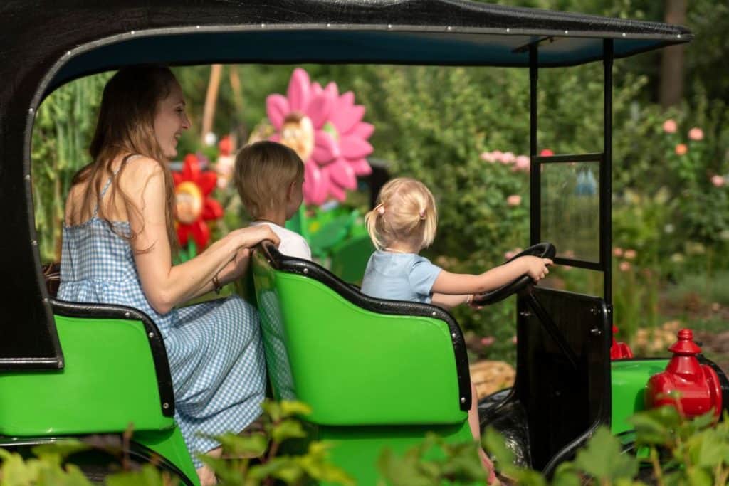 Travel nanny supervising children during family vacation activities and excursions.