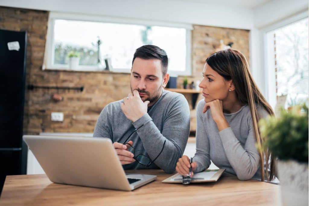 Parents calculating childcare expenses while planning a competitive nanny salary.