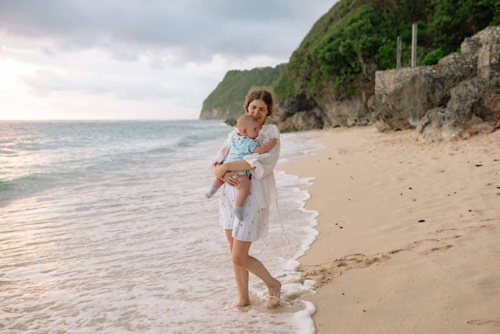 Luxury travel nanny assisting children during family travel.