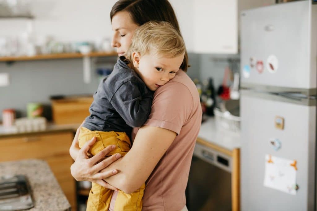 Caring nanny comforting a child and supporting healthy emotional expression.