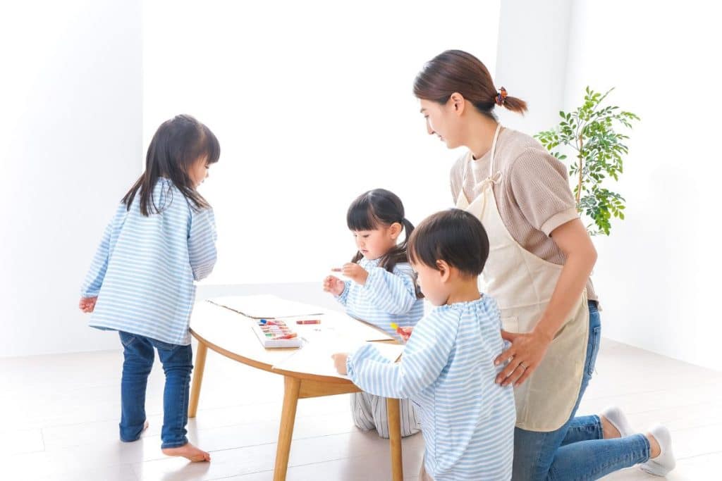 Professional nanny supporting children's learning and development through educational activities