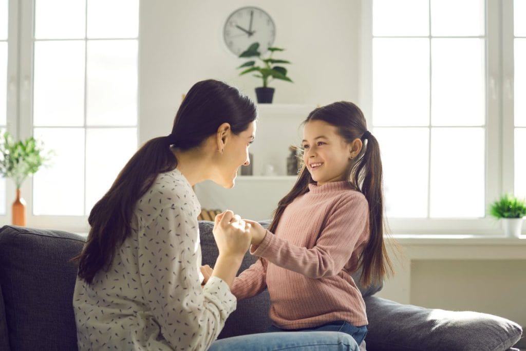Nanny and parents discussing childcare routines and family expectations