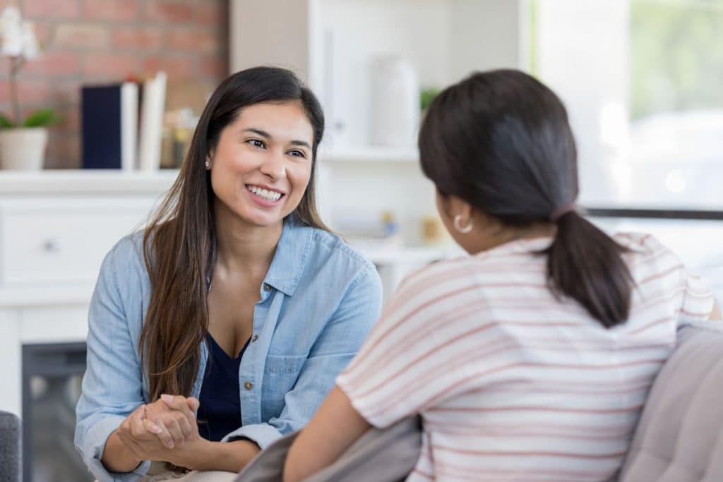 Parents and nanny discussing childcare expectations and professional boundaries