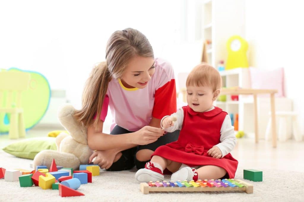 Parents evaluating nanny interaction with children during a trial day