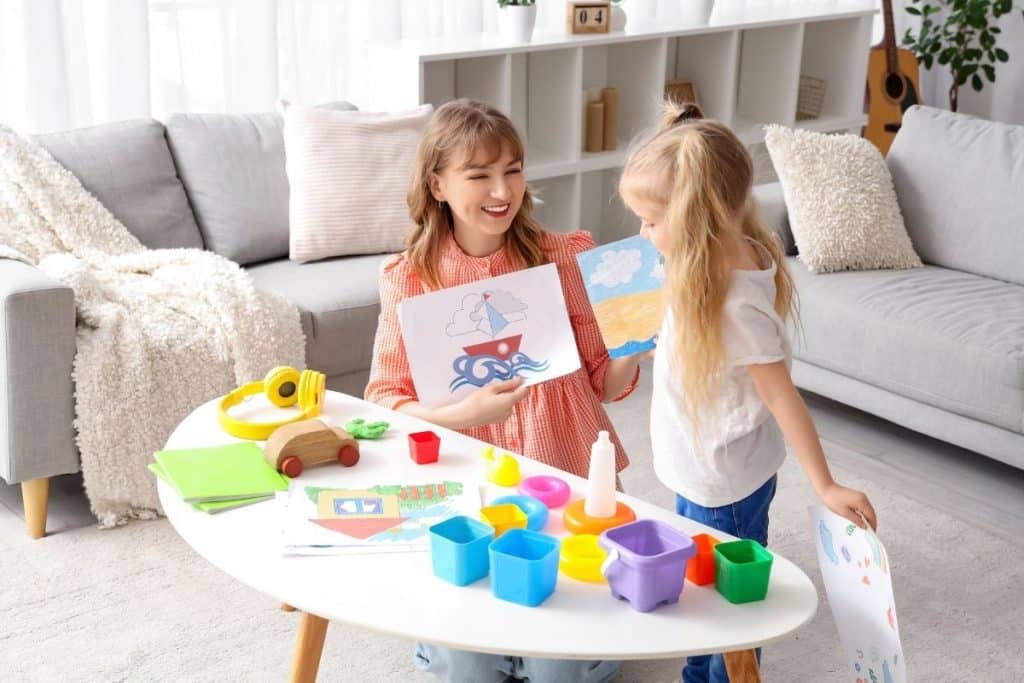 Professional nanny helping a young child transition between activities