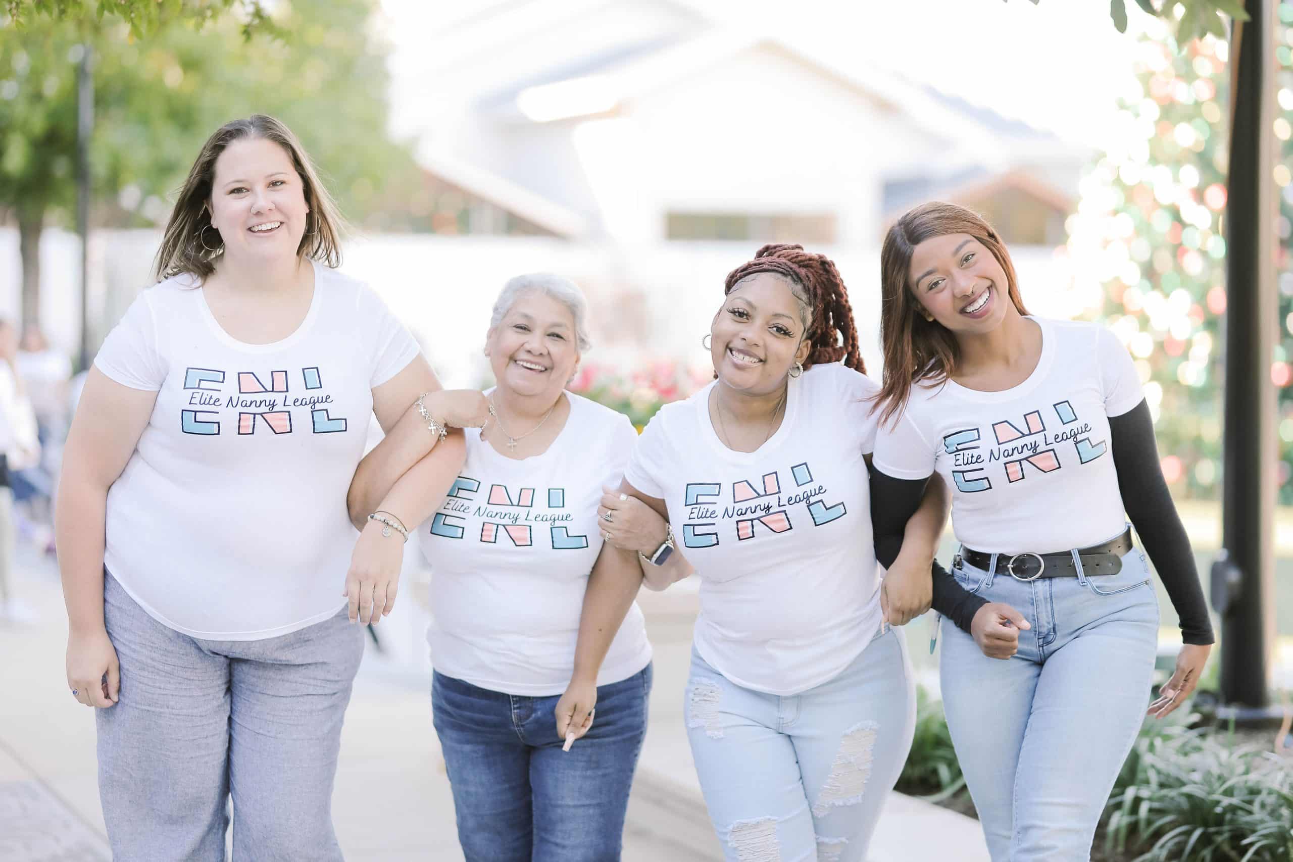 Four professional nannies from Elite Nanny League standing together during a team photoshoot.
